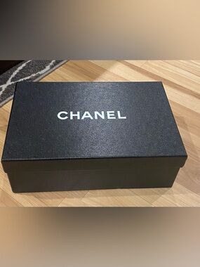 Black Chanel box with white logo and Made in Italy stamp.
